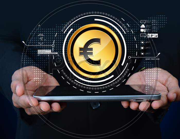 Close up shot of a Person's Hands holding Tablet or iPad with Euro Currency Coin