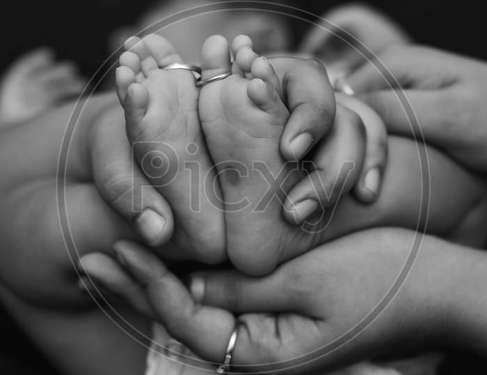 New born child being held by their parents. Lovely experience for father's day