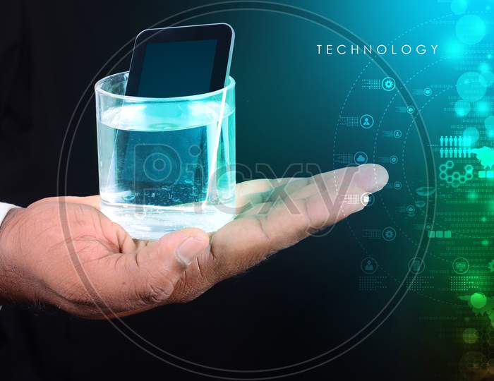 Man Hand Showing A Glass Of Water And Tablet Phone