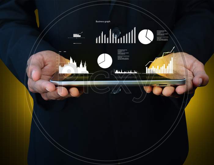 Close up shot of Person Using Tablet with Growth Bars and Pie Charts on Screen