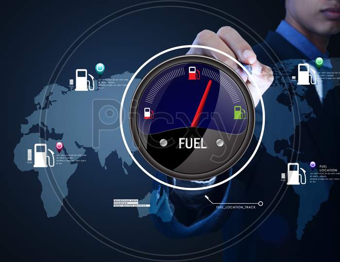 Close up shot of a Person's Hand pointing towards a Fuel Indicator