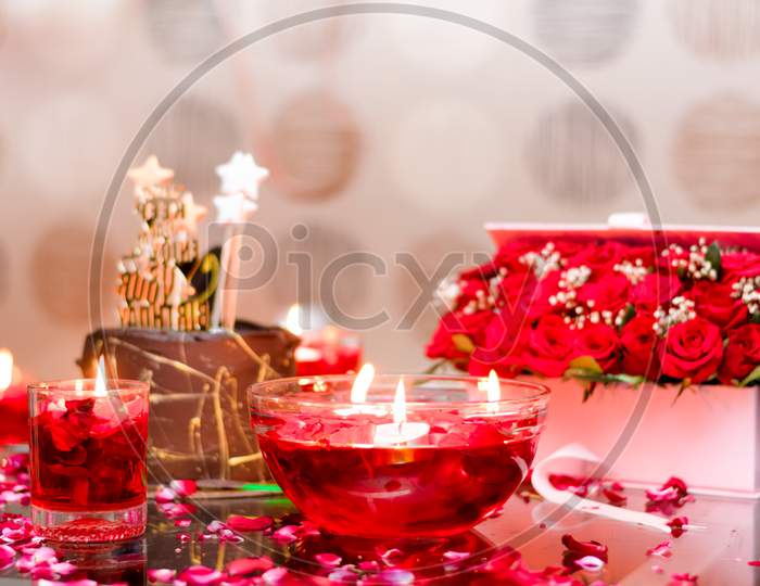 Decoration Of Red Flowers And Candles For Celebration.