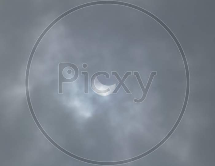 Partial Solar Eclipse On A Cloudy Day