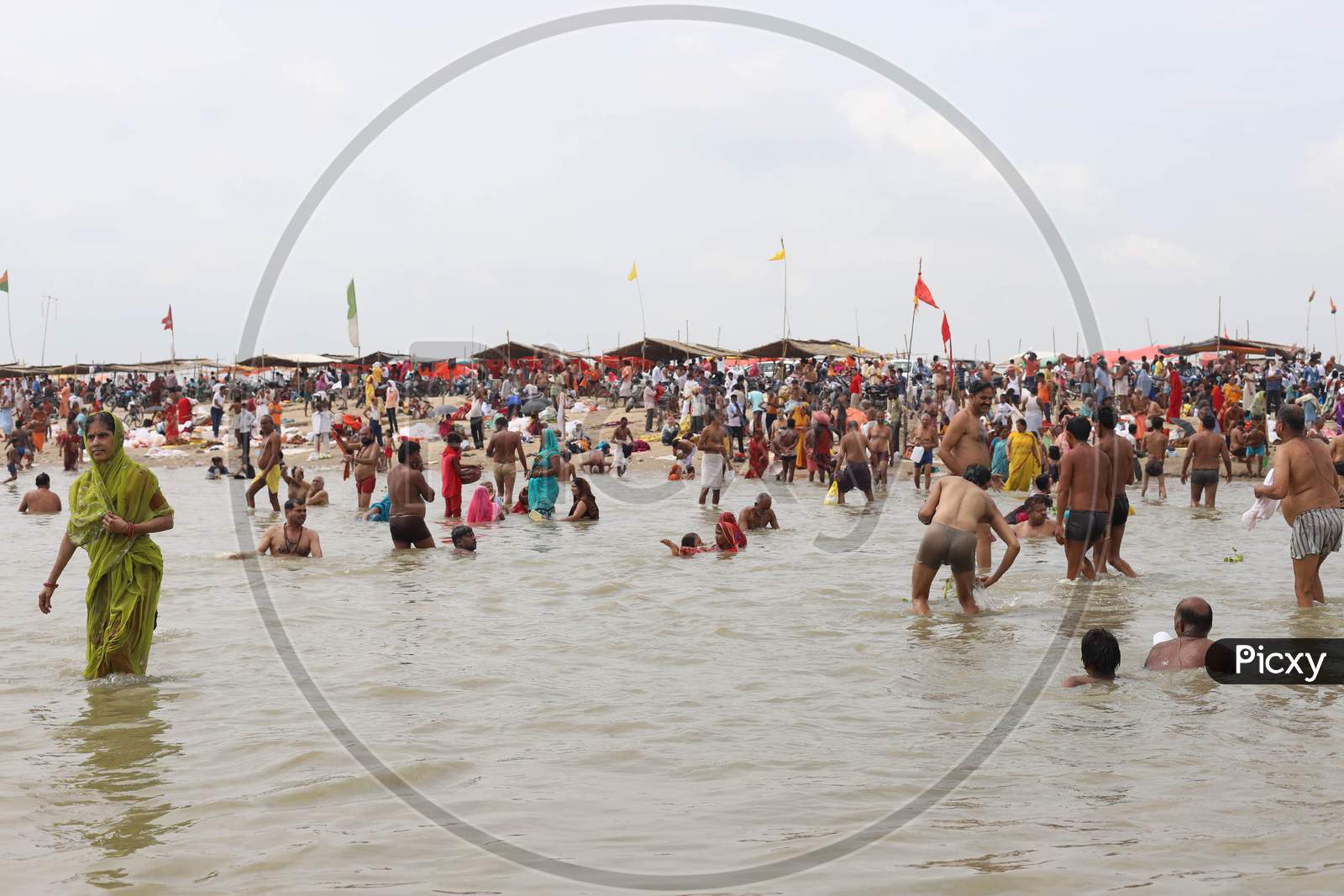 Hindu Devotees Takes Holy Dip In The Sangam, Confluence Of Three Rivers The Ganga, Yamuna And Saraswati During Solar Eclipse In Prayagraj, June 21, 2020.