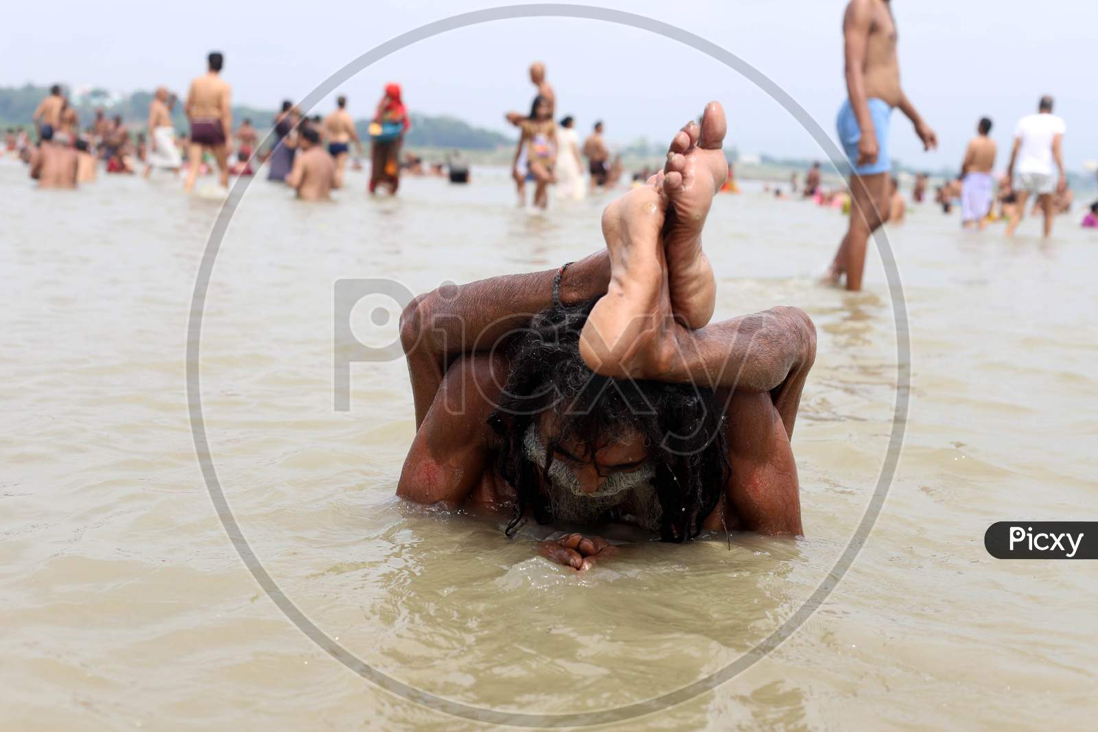 A Sadhu Performs Yoga In The River Ganga  On The Occasion Of International Yoga Day In Prayagraj, June 21, 2020.