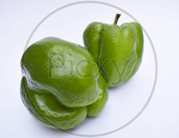 Close Up Of Big Green Capsicum Or Green Bellpepper On White Background. Fresh Glossy Vegetable Fruit