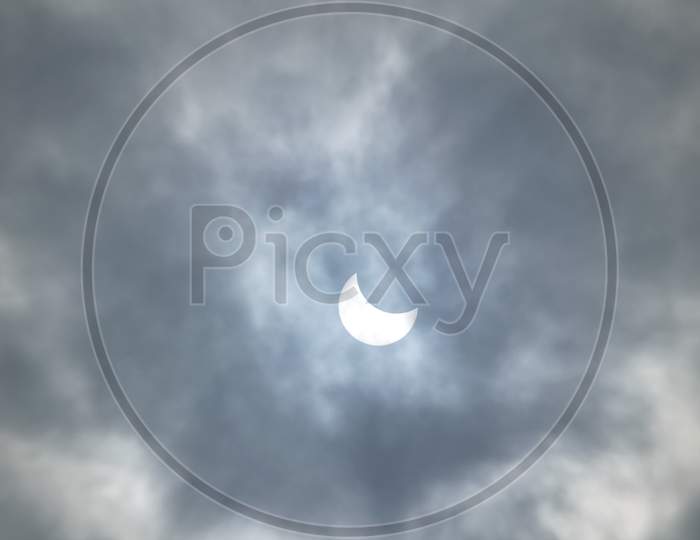 Partial Solar Eclipse On A Cloudy Day