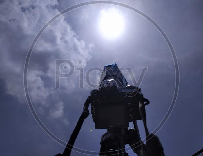 2020 June 21 - Ahmadabad, India . X-ray film put on camera lens and capture solar eclipse on the roof top .