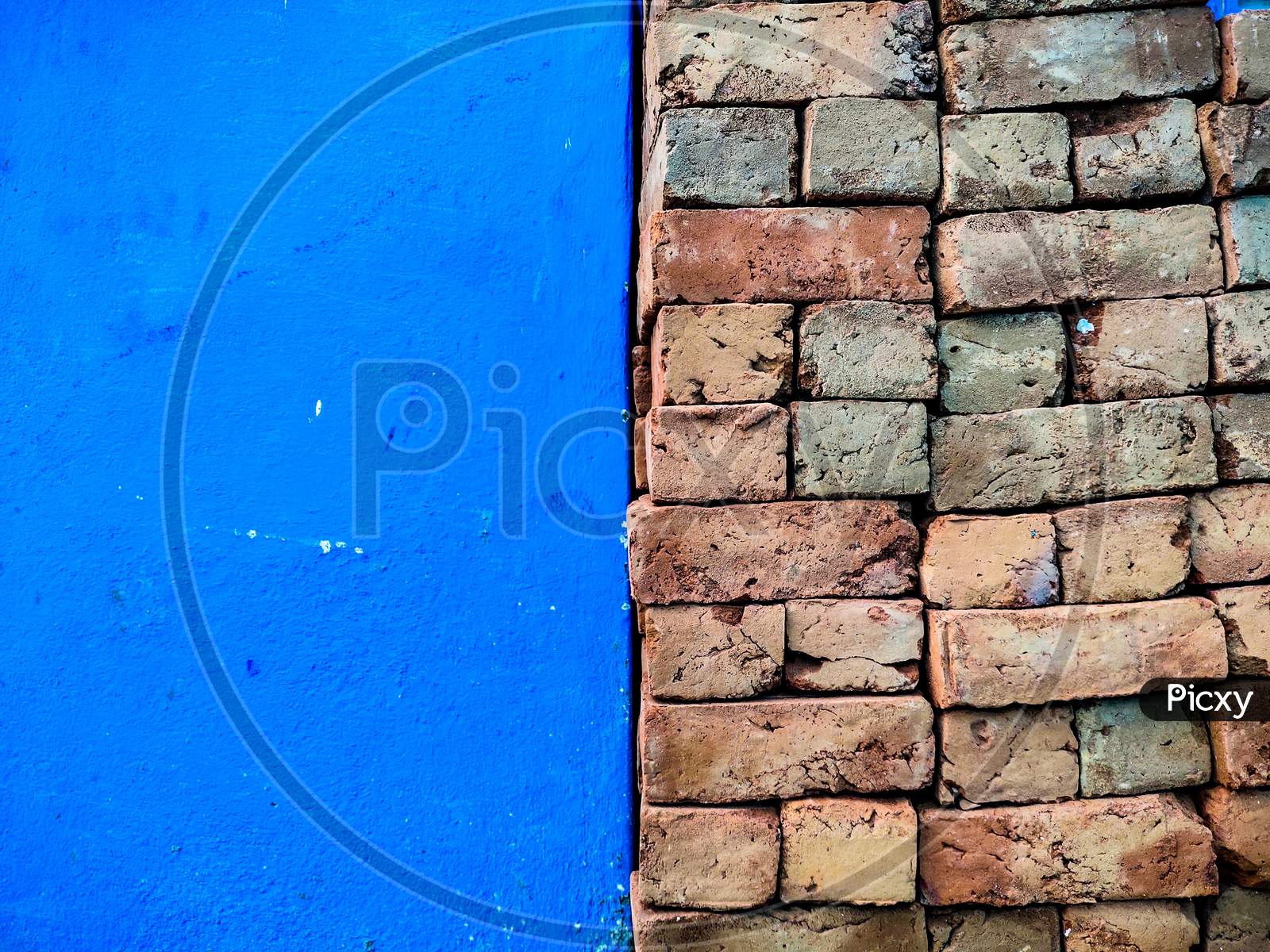 Old Grunge Color Brick Wall Background With Blue Wall Space For Copy Text.