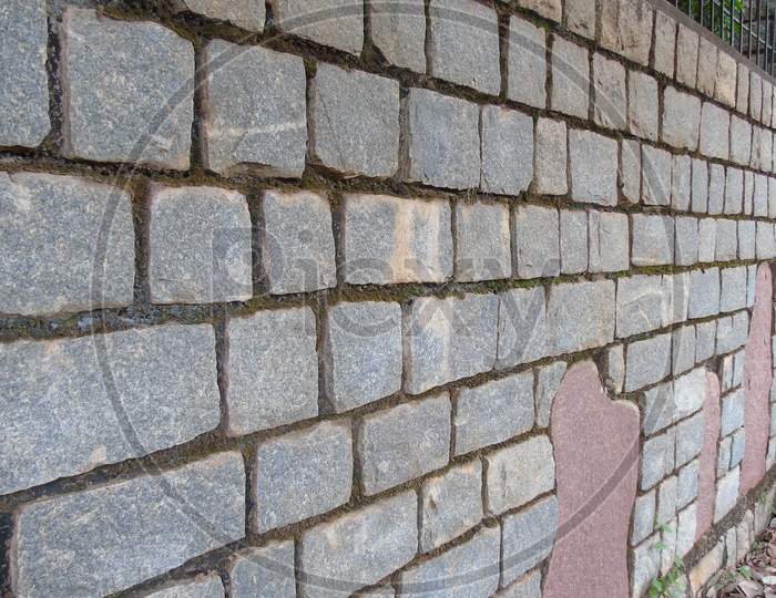 fencing with red and grey stone
