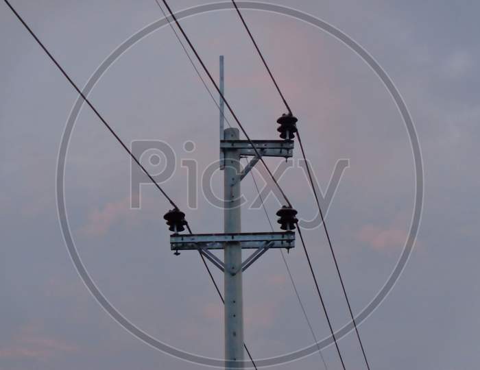 Electric pole having wire in sky background