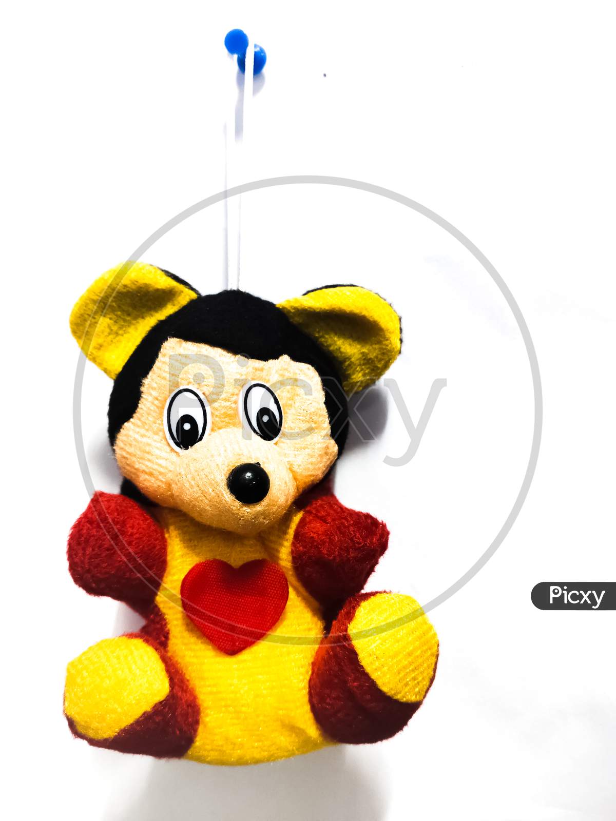Chennai, India March 11th 2020 : Mickey mouse toy hanging on wall isolated on white background.