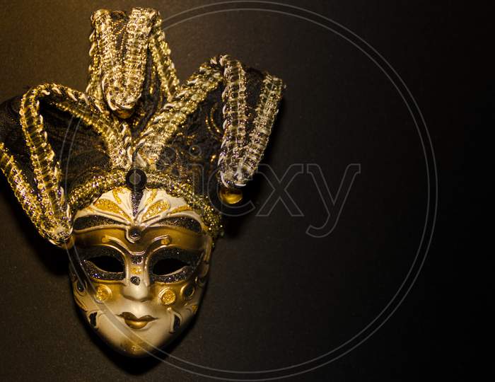 Masks And Feathers Of Venice Carnival On Black Background