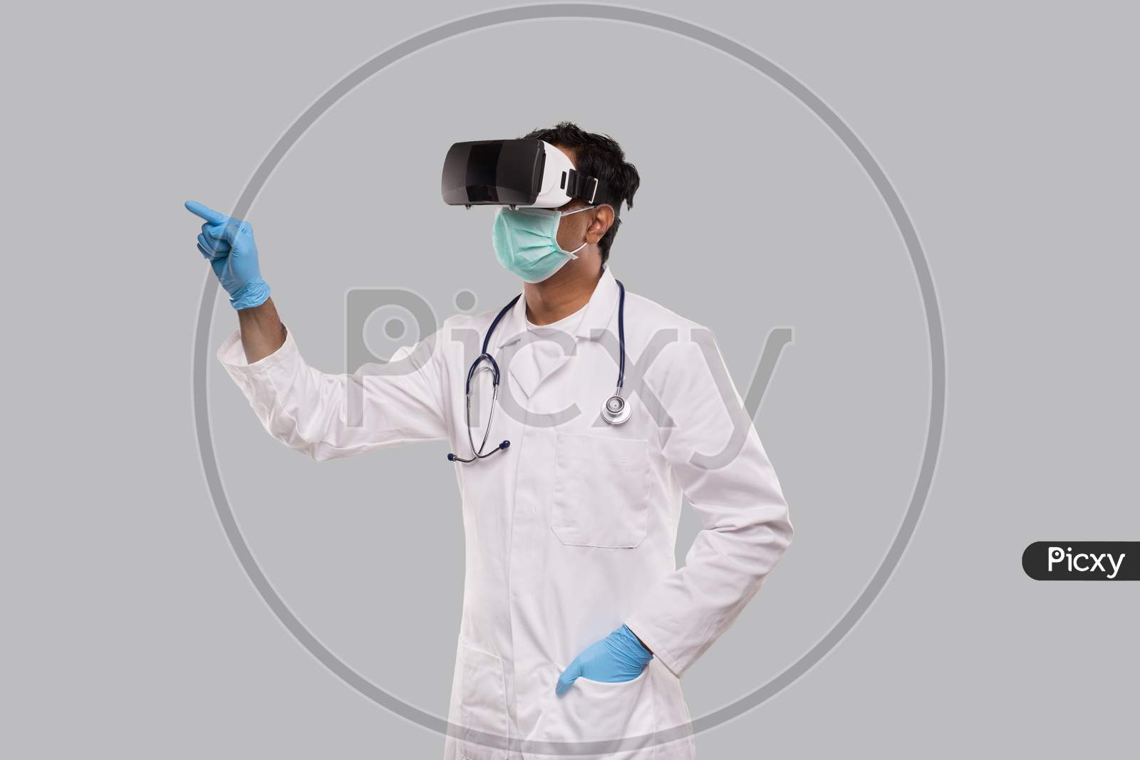 Doctor Wearing Vr Glasses, Medical Mask And Gloves Tapping Isolated. Indian Man Doctor Pointing In Virtual Reality