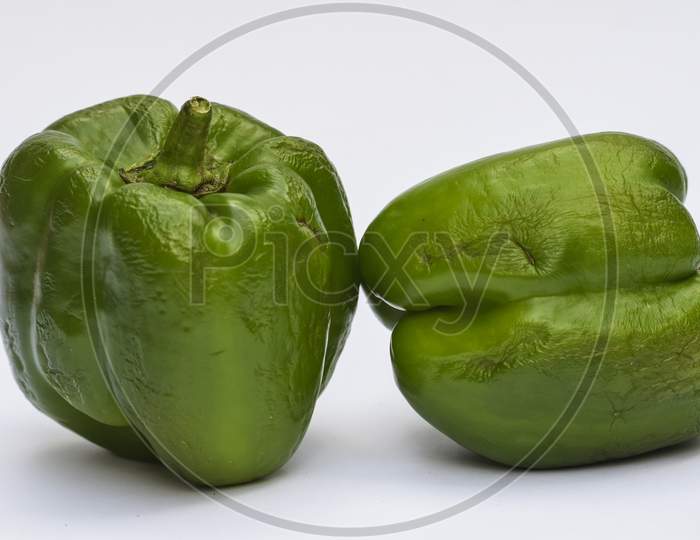 Close Up Of Big Green Capsicum Or Green Bellpepper On White Background.