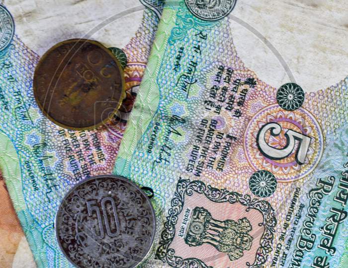 Background Image Of Old Indian Currency Notes And Coins.
