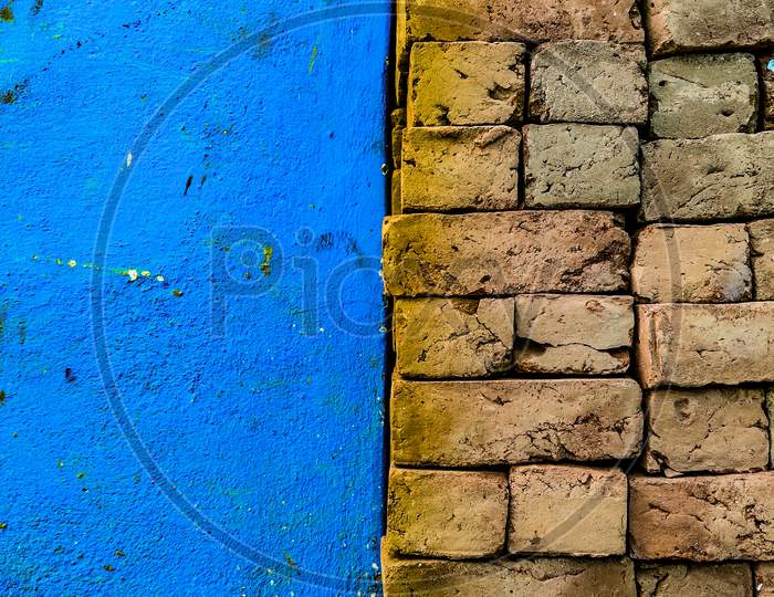 Old Grunge Color Brick Wall Background With Blue Wall Space For Copy Text.
