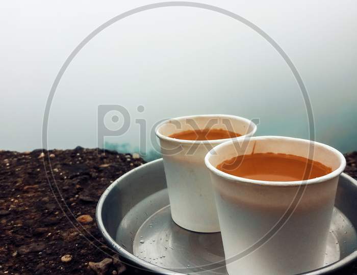 Two Tea Served In White Paper Cups Kept In Steel Tray.