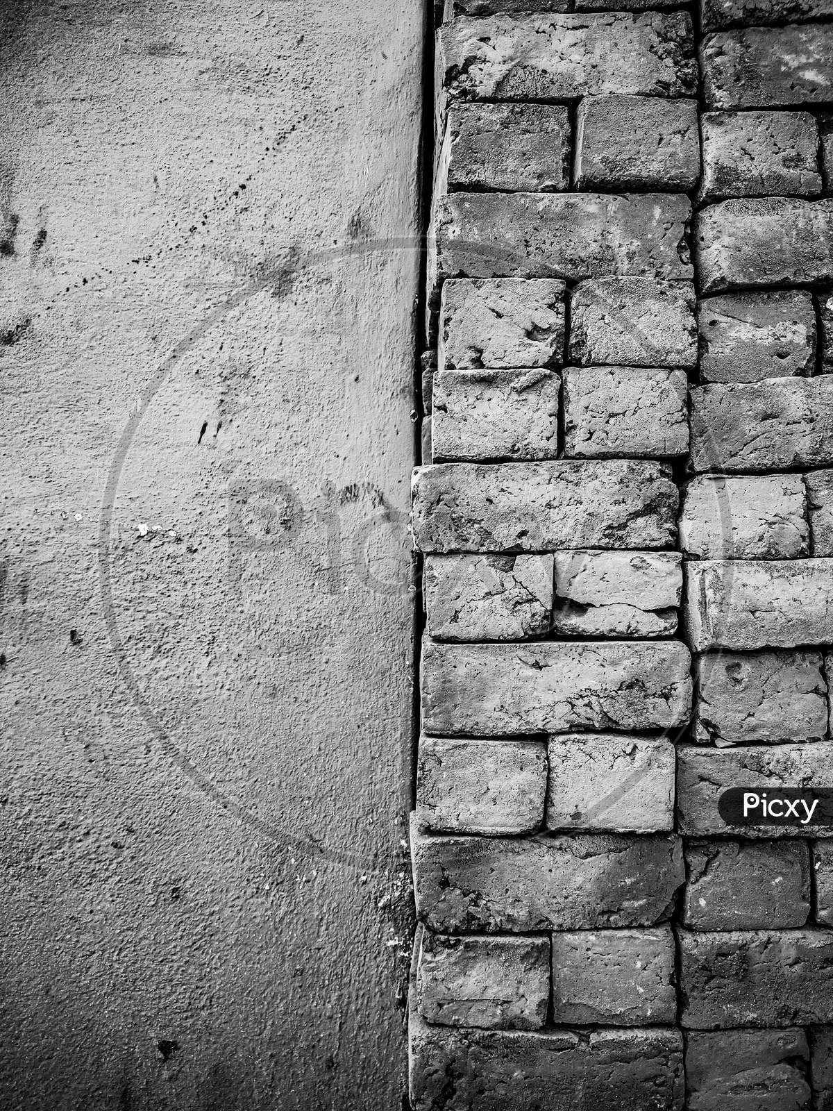 Old Grunge Monochrome Brick Wall Background With Empty Wall Space For Copy Text.