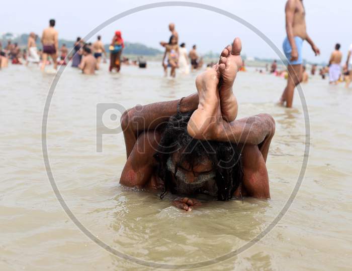 A Sadhu Performs Yoga In The River Ganga  On The Occasion Of International Yoga Day In Prayagraj, June 21, 2020.