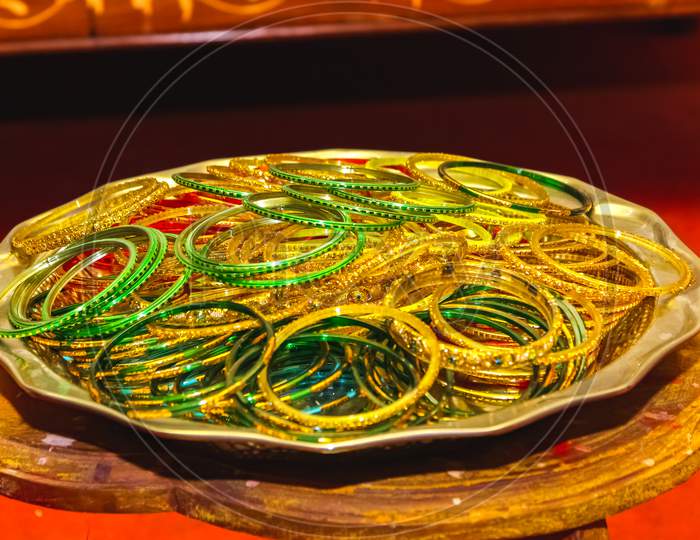 Colorful Indian Bangles. Stacks Of Beautiful Colorful Indian Bangles For Bride On Sliver Plate. Glass Bangles On Steel Plate.