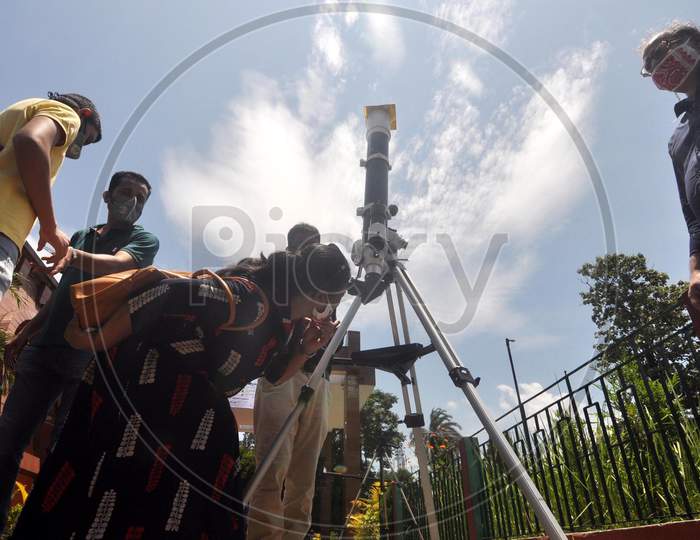 People Looks Through A Telescope To Get A Glimpse Of Solar Eclipse, At Guwahati Planetarium In Guwahati, Sunday, June 21, 2020.