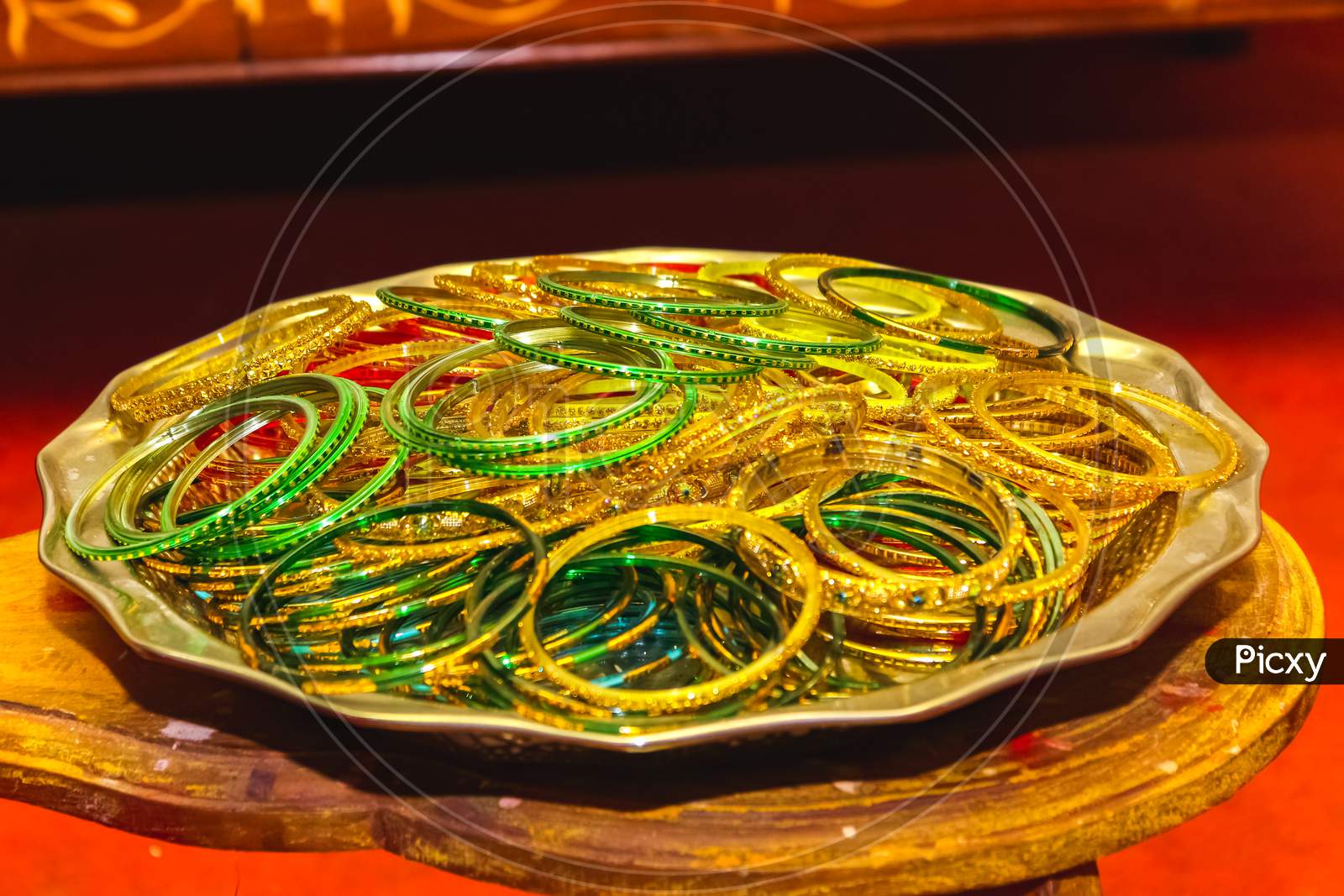Colorful Indian Bangles. Stacks Of Beautiful Colorful Indian Bangles For Bride On Sliver Plate. Glass Bangles On Steel Plate.