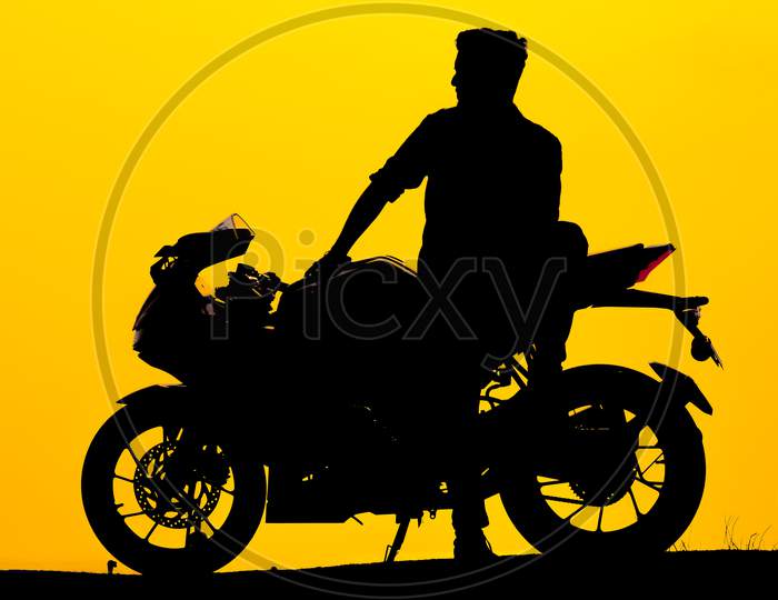 Chennai, India - March‎ ‎8‎Th ‎2019 : Silhouette Of Young Biker With Motorcycle. Biker On Motorcycle Isolated On Silhouette Sunrise Sky Background.