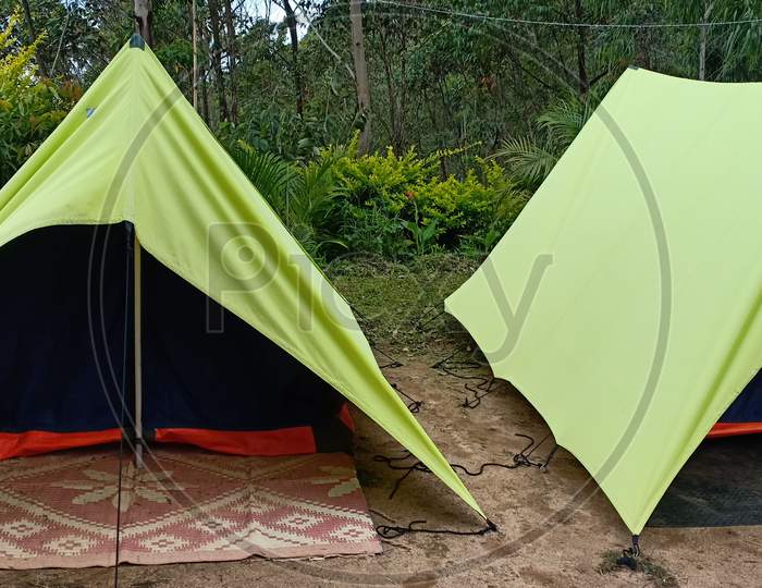 Triangle Tent Camping Near Mountain Forest. Camping Tent In The Top Of Mountain In The Morning Background Forest