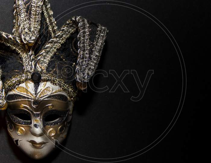 Masks And Feathers Of Venice Carnival On Black Background