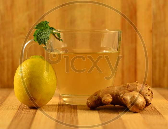 A Cup Of Green Tea In A Wooden Background.