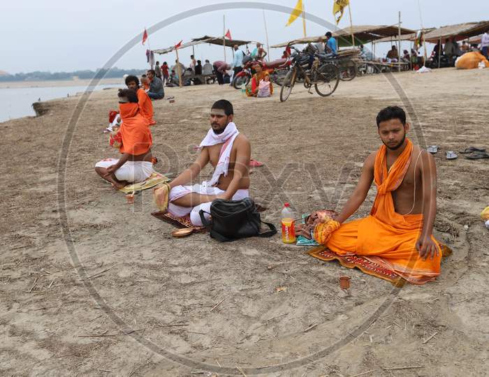 Hindu priests offers Prayers To The Sun At The Sangam, The Confluence Of The Rivers Ganges, Yamuna And Saraswati, During An Annular Solar Eclipse In Prayagraj, June 21,2020