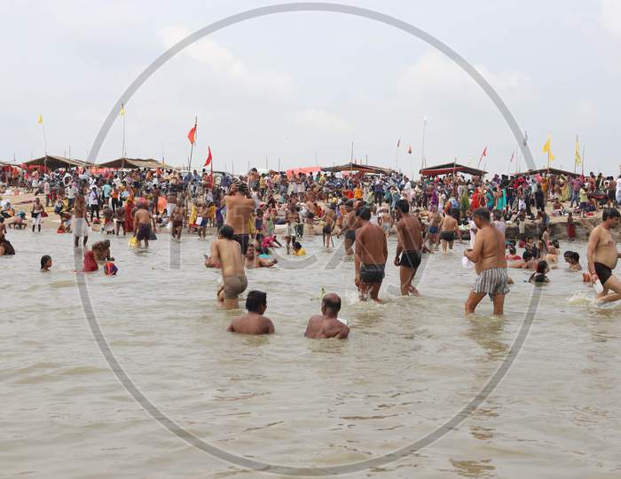 Hindu Devotees Take Holy Dip In The Sangam, Confluence Of Three Rivers The Ganga, Yamuna And Saraswati During Solar Eclipse In Prayagraj, June 21, 2020.