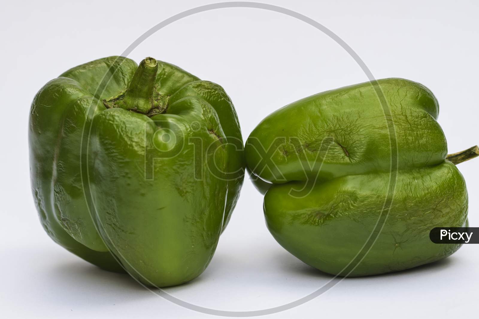 Close Up Of Big Green Capsicum Or Green Bellpepper On White Background.
