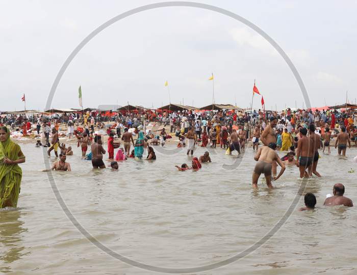 Hindu Devotees Takes Holy Dip In The Sangam, Confluence Of Three Rivers The Ganga, Yamuna And Saraswati During Solar Eclipse In Prayagraj, June 21, 2020.