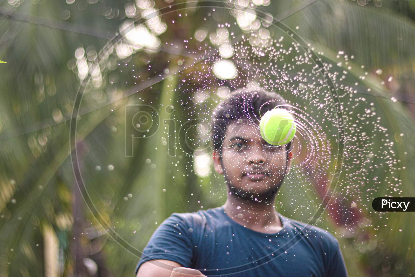 Water galaxy  with wet tennis ball in front of a Asian man