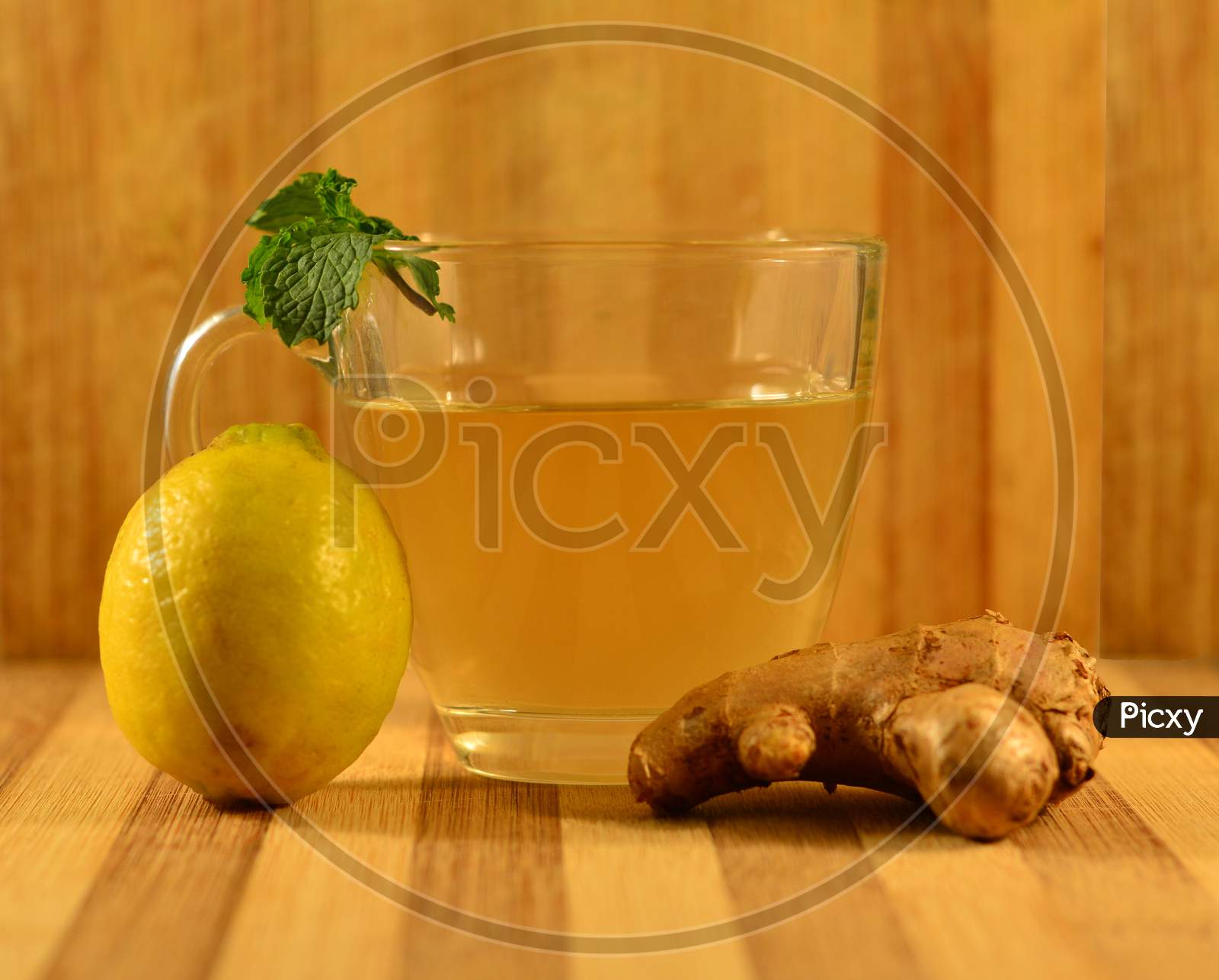 A Cup Of Green Tea In A Wooden Background.