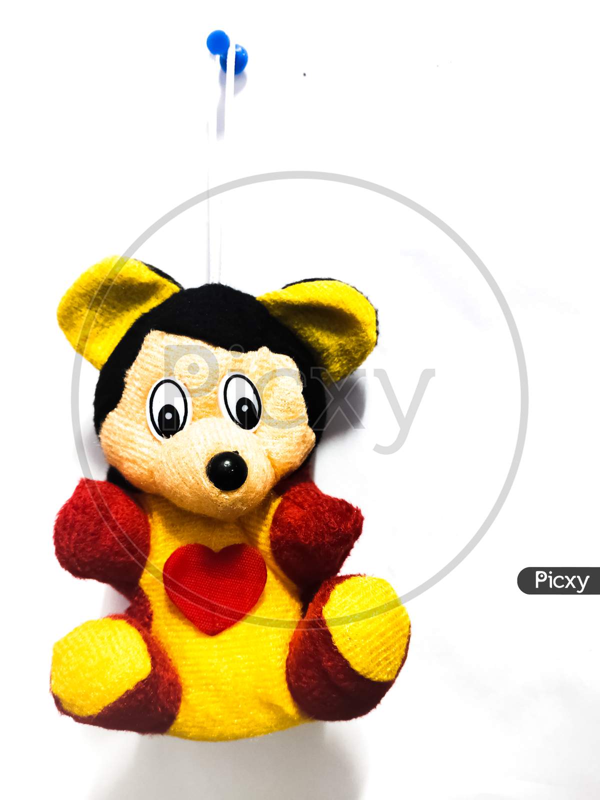 Chennai, India March 11th 2020 : Mickey mouse toy hanging on wall isolated on white background.