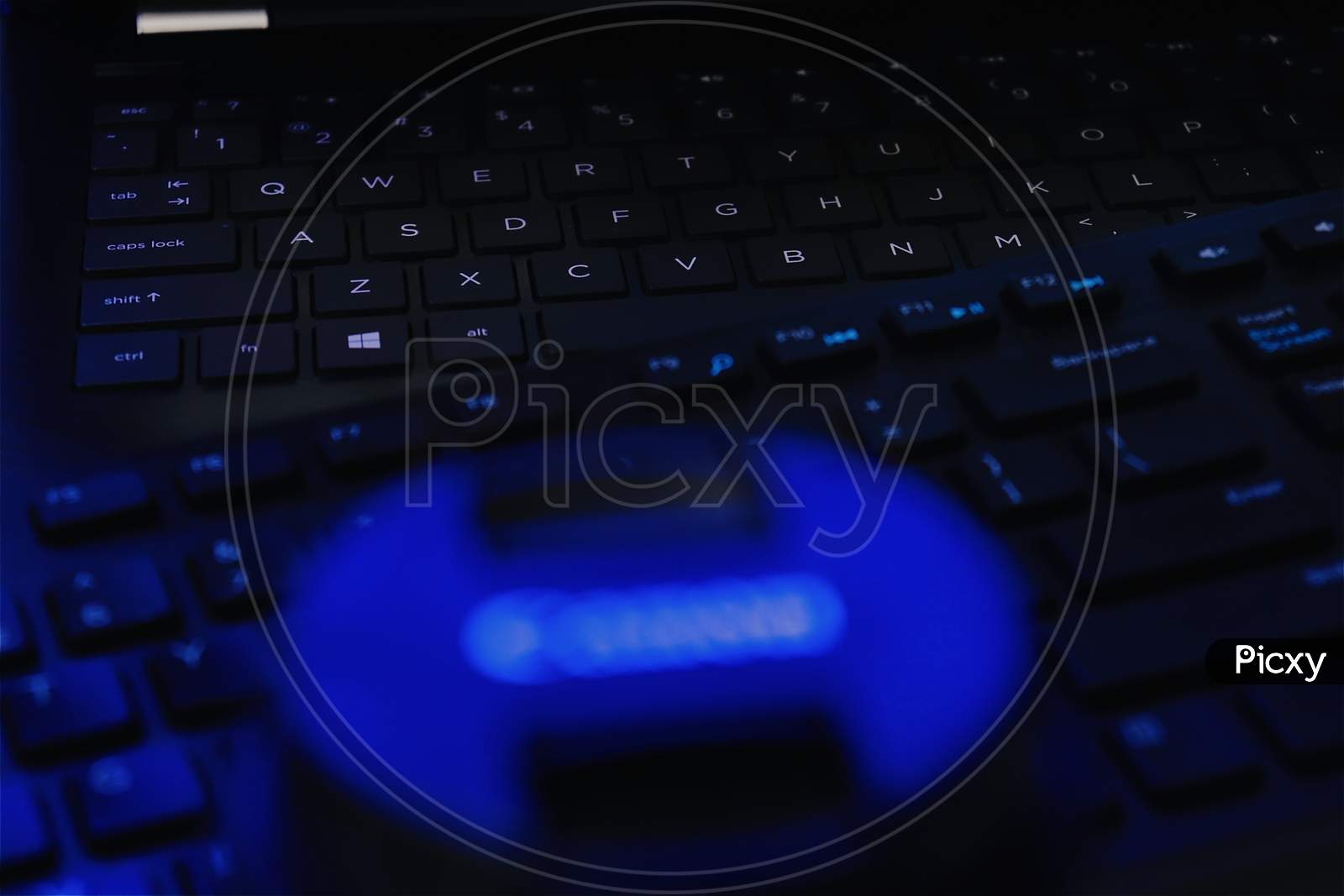 close up of a keyboard in blue low light