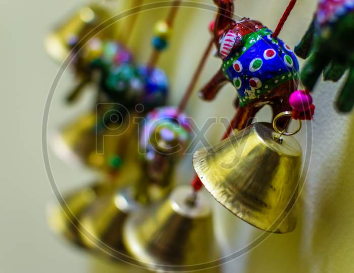 Golden Colored Bells And Elephant Soft Toys . Selective Focusing On The Bell And A Elephant Toy