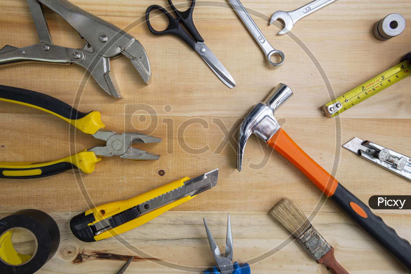 A High Angle Shot Of Many Working Instruments On A Light Wooden Surface. Construction Tools On Wooden Background Shot From Above. Top View, Flat Lay. Construction, Repair, Production And Diy Concept.