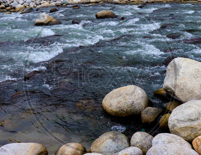 Flowing River Having Rocks In The River