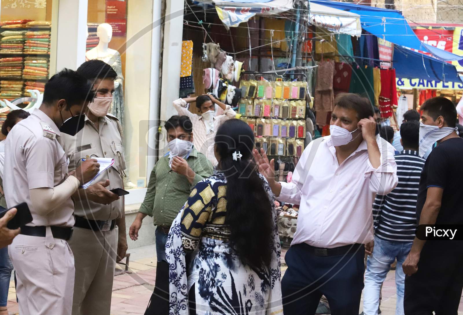 Delhi Police fine people for violating the measures for not wearing face masks, at Lajpat Nagar market, On June 20, 2020 In New Delhi, India.