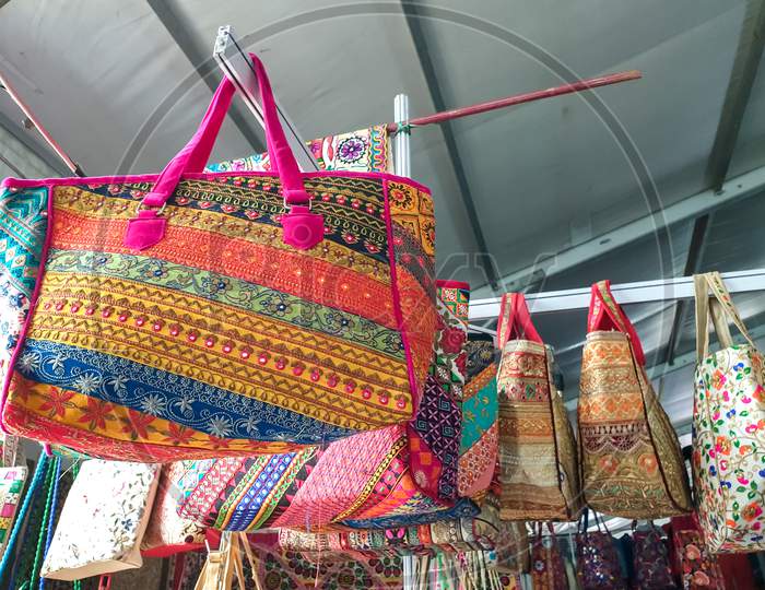 Mandi, Himachal Pradesh / India - February 28 2020: Photo of beautiful Rajasthani artwork hand bags hanging in shop and fair of India