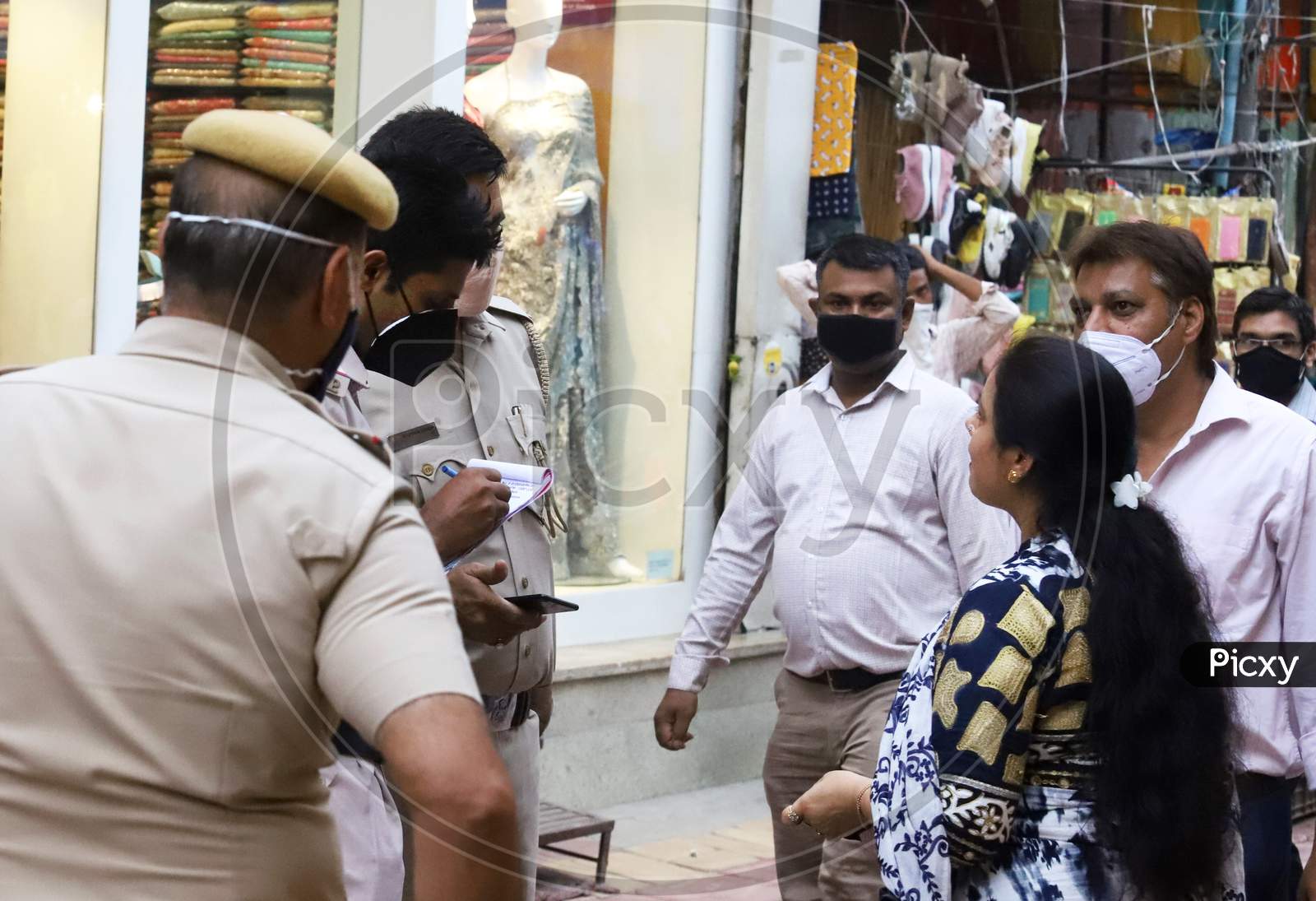 Delhi Police fines people for violation of lockdown measures for not wearing face masks, at Lajpath Nagar market, On June 20, 2020 In New Delhi, India.
