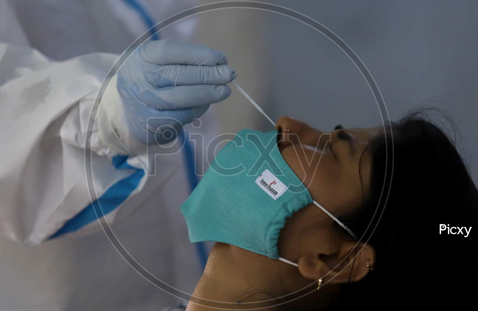 A Health Worker Collects A Swab Sample From A woman At A Covid-19 Testing Centre, Near Asaf Ali Road, On June 22, 2020 In New Delhi, India.
