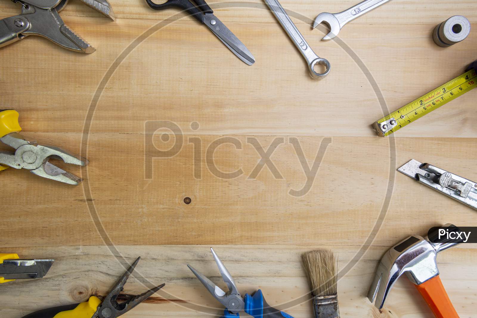 Working Instruments Scattered On A Wooden Surface With Space For Text In The Center