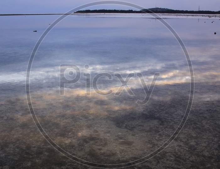 Clouds Reflected On Calm Water On Exotic Island