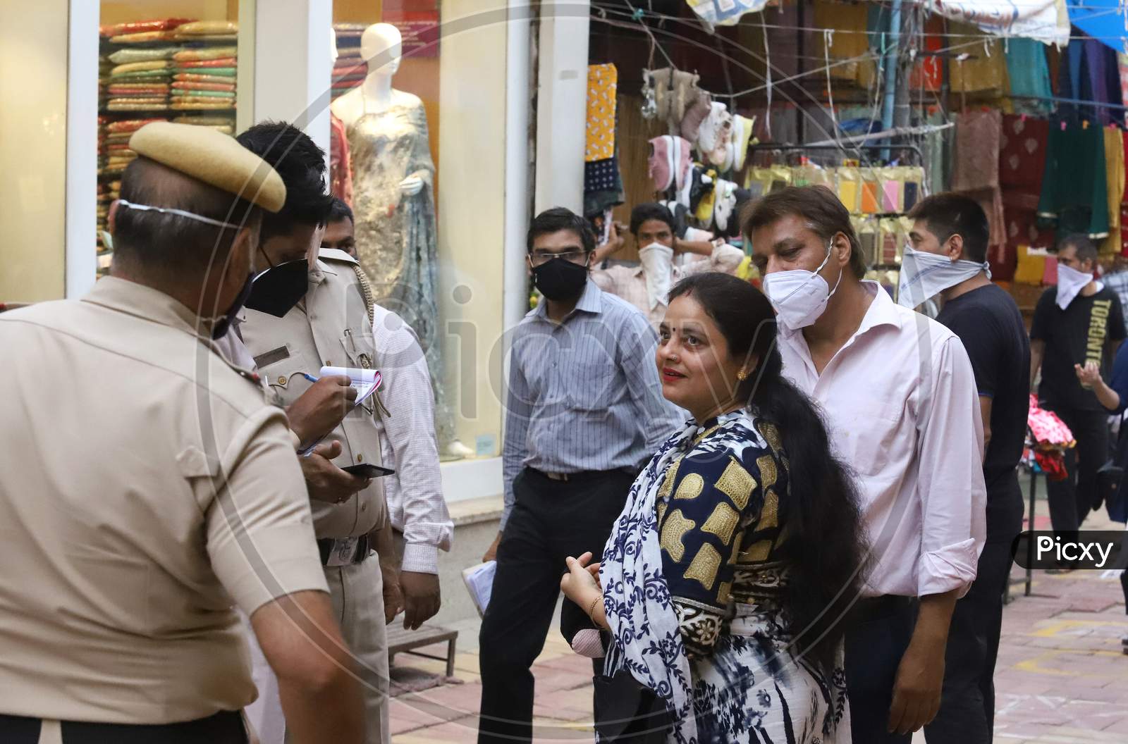 Delhi Police fine people for violating the measures for not wearing face masks, at Lajpat Nagar market, On June 20, 2020 In New Delhi, India.