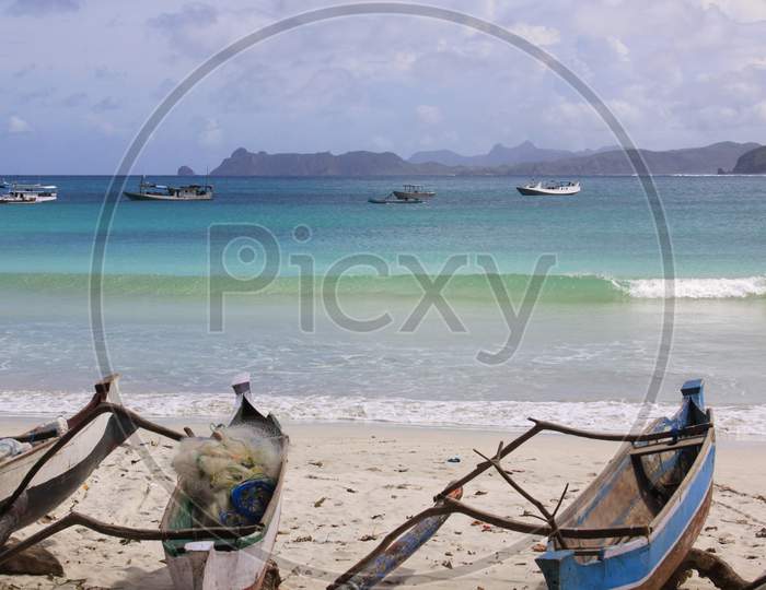 Small Jukung Boats And Breaking Wave In Lombok